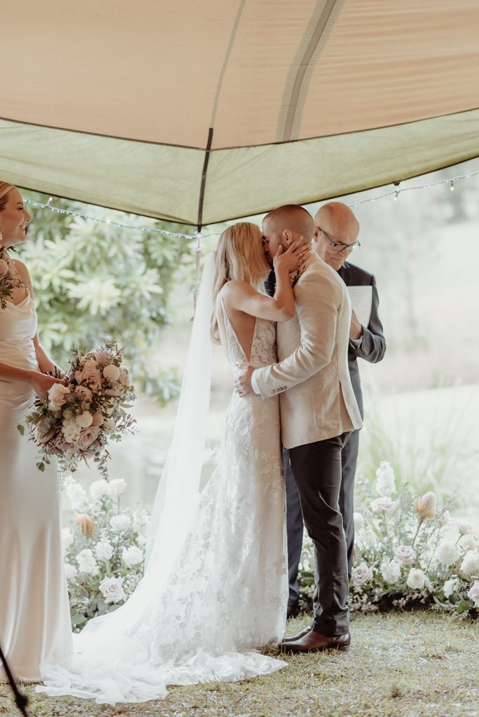 first kiss at wedding ceremony, tipi tent wedding