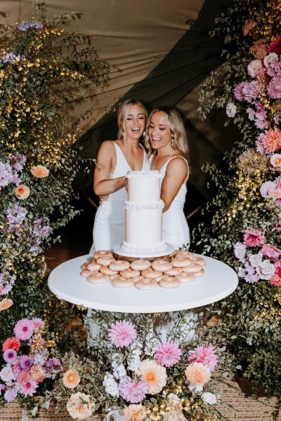 The Acre Boomerang Farm Tipi Wedding Same Sex cutting cake